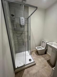 A modern bathroom featuring a walk-in shower wi...