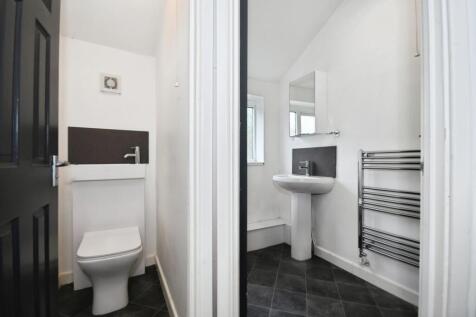 Bright, modern bathroom with sleek tiled floor...