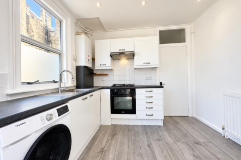 Bright Modern L-Shaped Kitchen Interior.png