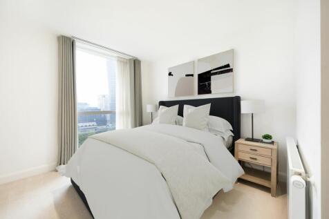 Experience comfort and style with this chic bedroom offering stunning city views.