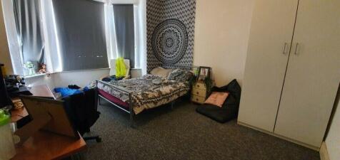 Spacious master bedroom with large bay windows...