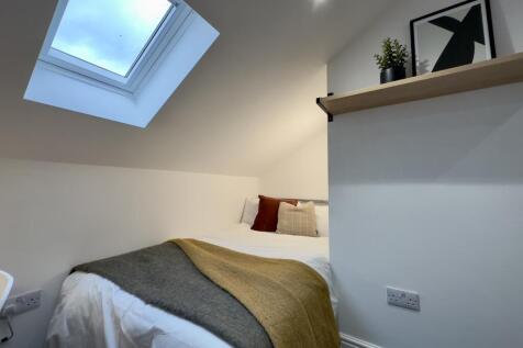 A bright and cozy double bedroom featuring styl...