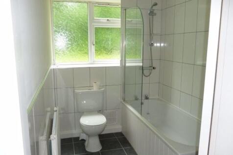 Bright, clean bathroom with a modern white suit...