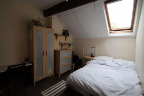 A cozy and well-maintained bedroom featuring a ...