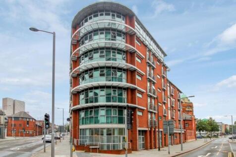 Modern apartment building exterior under blue s...