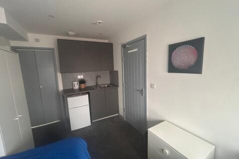 Compact room with kitchenette and storage...