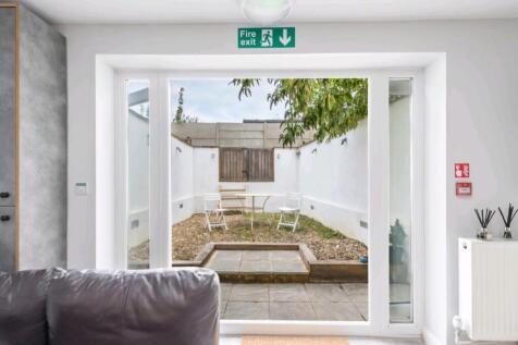 Bright private courtyard with seating area...