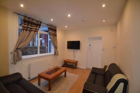 A bright and welcoming living room featuring tw...