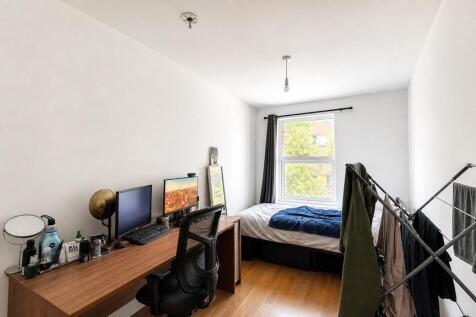Bright bedroom with large desk and natural ligh...
