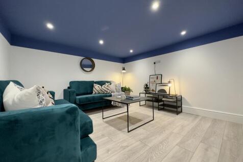 A spacious and inviting modern living room feat...