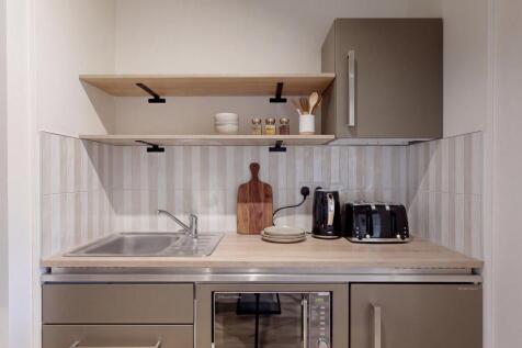 Sleek modern kitchenette with elegant finishes....