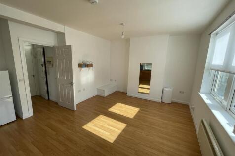 Bright living room with sleek wood-style floori...