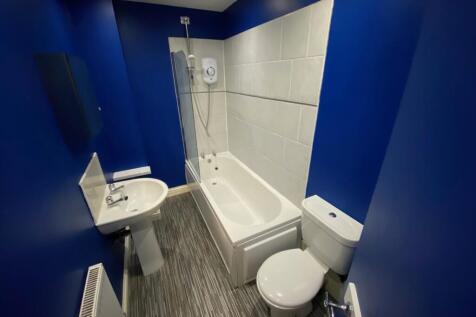 A modern and clean bathroom featuring a bath an...