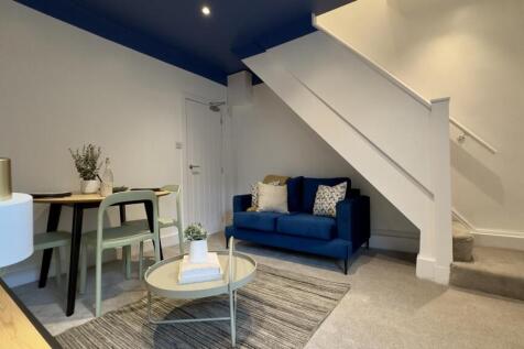 A stylish and inviting living room with modern ...