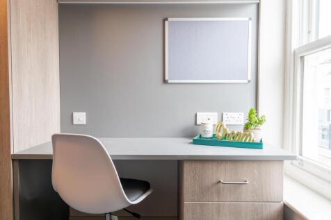 Bright, tidy study area with a smooth grey desk...