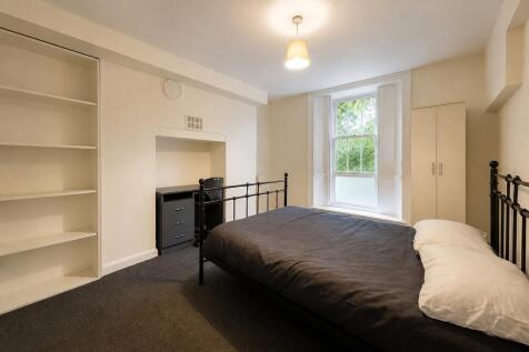 Bright bedroom with double bed and ample storag...