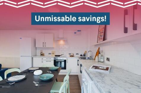 Bright modern kitchen with white cabinetry, mar...