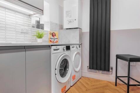 Modern laundry area with sleek designer radiato...