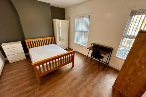 Bright, tidy bedroom with wooden floor, a doubl...