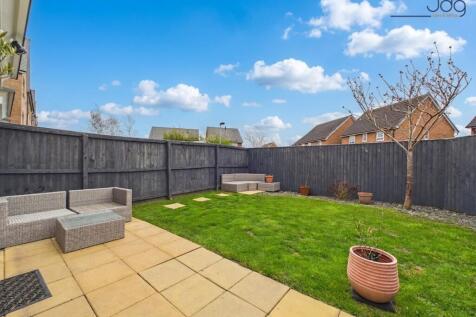South-facing garden with a lawn and patio