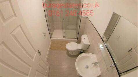 Modern, clean shower room with a large mirror...