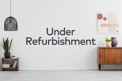 Retro, wooden cabinet and a painting in an empty living room interior with white walls and copy space place for a sofa. Real photo.