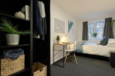 A bright and inviting double bedroom with styli...