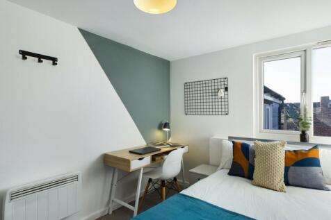 A bright and inviting double bedroom featuring ...
