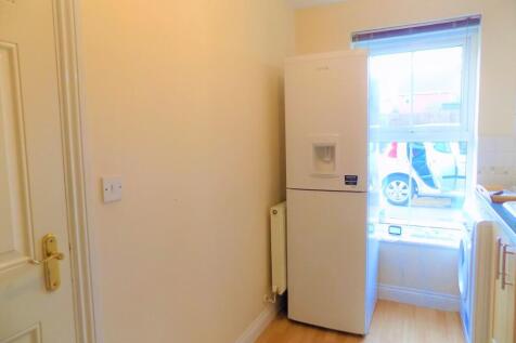 Bright kitchen area with a modern fridge freeze...
