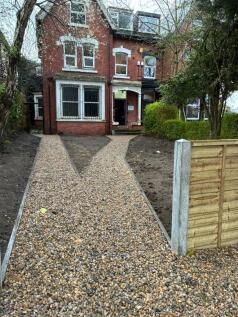 Charming red brick house with graveled path...