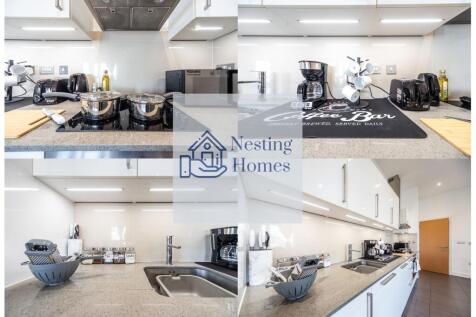 A modern, sleek kitchen featuring a polished gr...