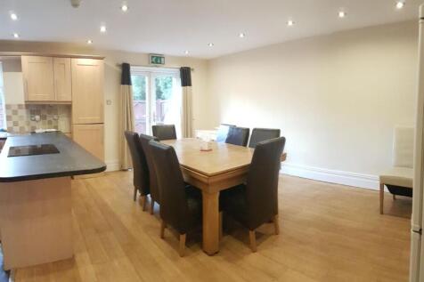 Bright open-plan kitchen and dining area with w...