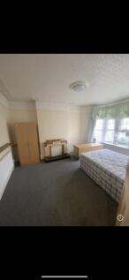 Spacious bright bedroom with classic fireplace...
