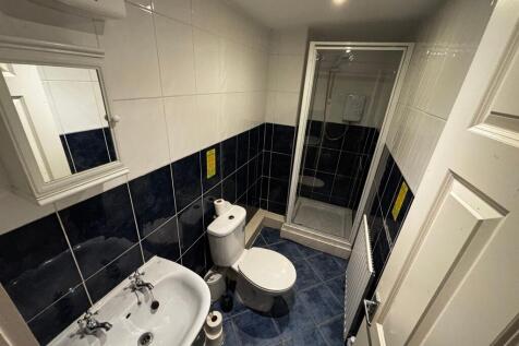 Neat tiled bathroom with a corner shower cubicl...
