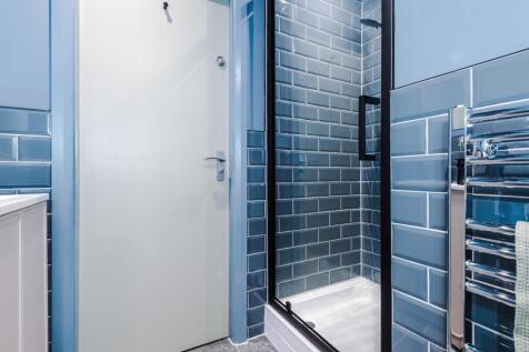 Contemporary bathroom with stylish blue subway ...