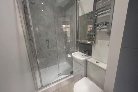 Modern tiled bathroom with shower cubicle...