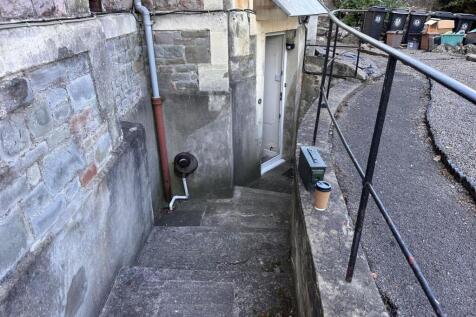 Exterior stone entrance with steps leading down...