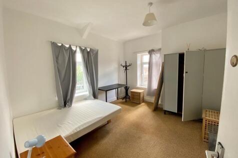 Bright spacious bedroom with ample storage spac...