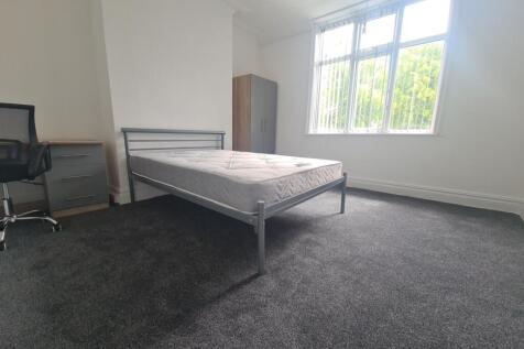 A bright and tidy bedroom featuring a double be...