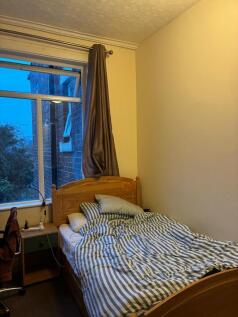 Bright bedroom with large window and comfy bed...