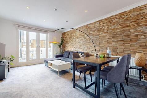 Bright, modern living area with large floor-to-...