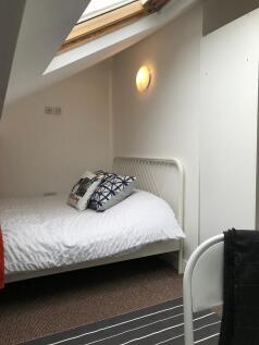 Bright attic double bedroom with a skylight, wh...
