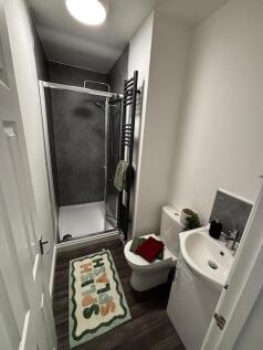 Modern compact bathroom with a walk-in shower, ...