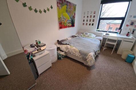 A cozy double bedroom featuring a comfortable d...