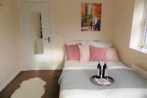 Bright, neatly styled double bedroom with a com...