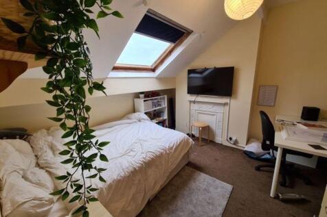 Bright and cozy master bedroom with a comfortab...