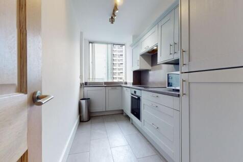 Modern kitchen with sleek cabinetry and natural...