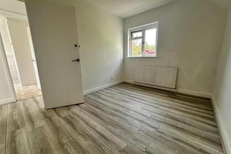 Bright bedroom with stylish wood-effect floorin...