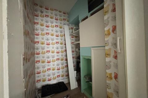Unique storage room with playful cat wallpaper...