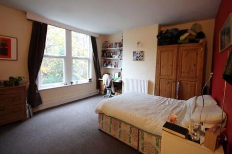 A cozy bedroom featuring a double bed, a large ...